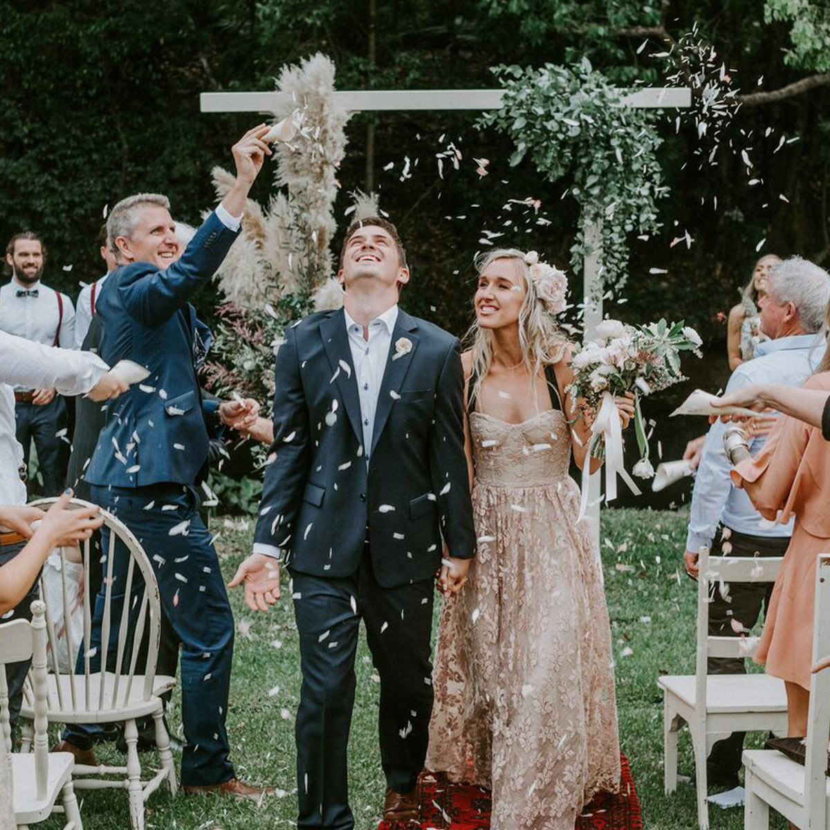 Confetti scattered across the garden lawn at a vintage-inspired boho wedding at Bangalow Guesthouse