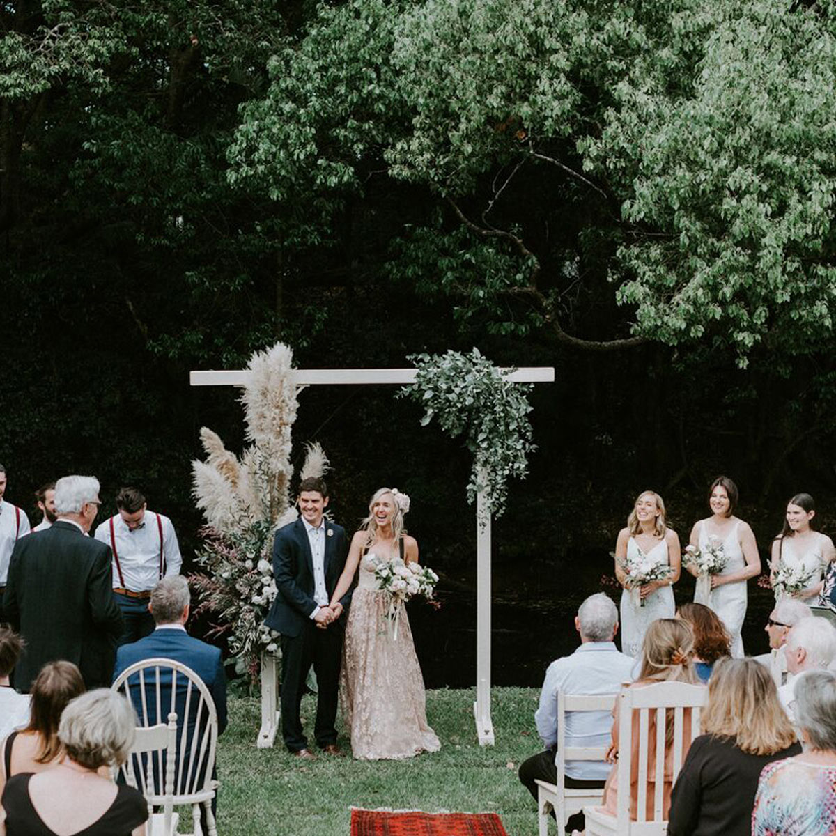 Bride and groom smiling after their kiss in the beautiful gardens of Bangalow Guesthouse