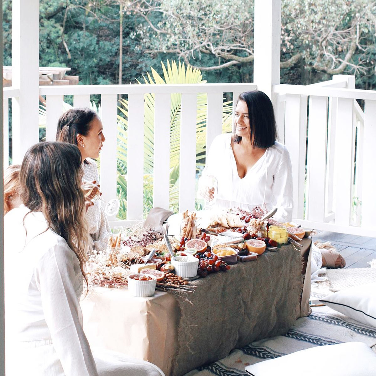 Guests enjoying a country-style tasting event with gourmet food in a lush garden setting @ Bangalow Guesthouse