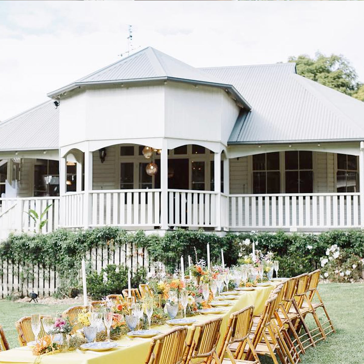 Large communal outdoor dining table set for a country-style dinner party at Bangalow Guesthouse