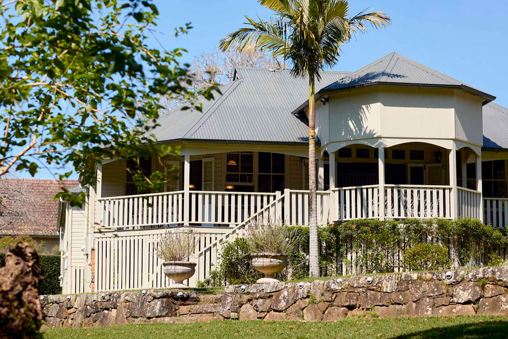 Heritage Bangalow Guesthouse exterior surrounded by lush gardens in the Byron Bay hinterland