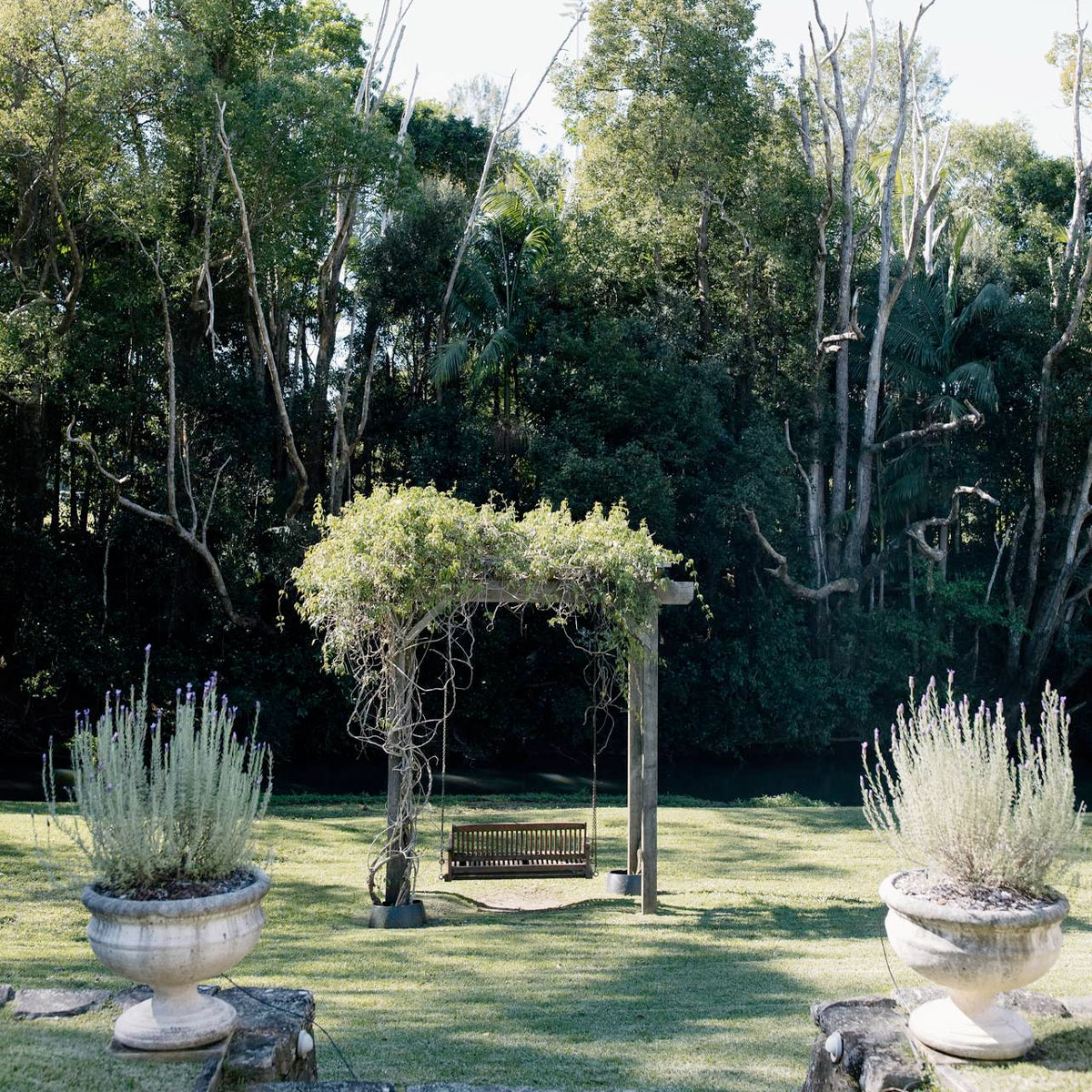 Bangalow Guesthouse Gardens — Relax on the Garden Swing Seat Beautiful garden swing seat among the lush three-acre gardens at Bangalow Guesthouse near Byron Bay hinterland