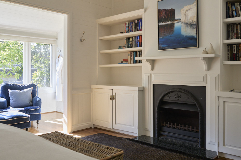 Dr Bracken Suite — Heritage Fireplace and Library, Bangalow Guesthouse Bespoke library and faux heritage fireplace mantel in the Dr Bracken Suite at The Bangalow Guesthouse