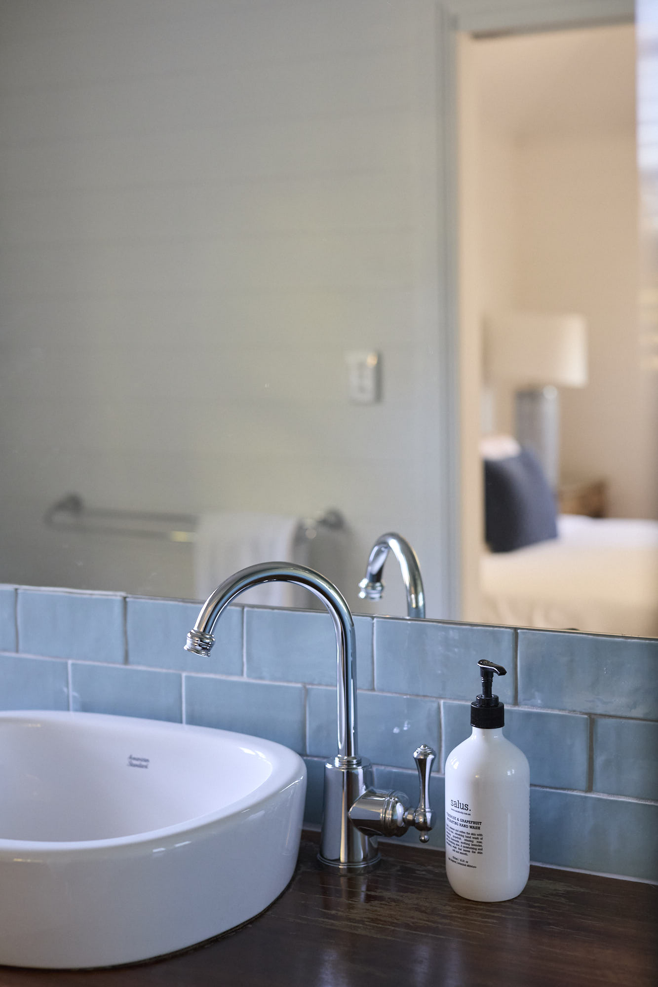 Elegant ensuite bathroom in the Miller Apartment at Bangalow Guesthouse featuring blue tiles and heritage-inspired design