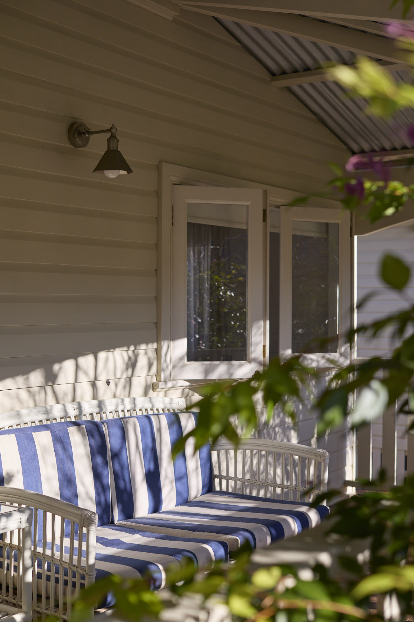 Comfy seating on the private garden-view balcony of Dr Lentaigne’s Cottage at Bangalow Guesthouse