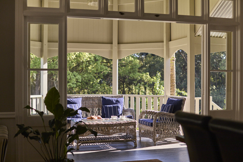Sitting area on the verandah at The Bangalow Guesthouse overlooking the heritage gardens