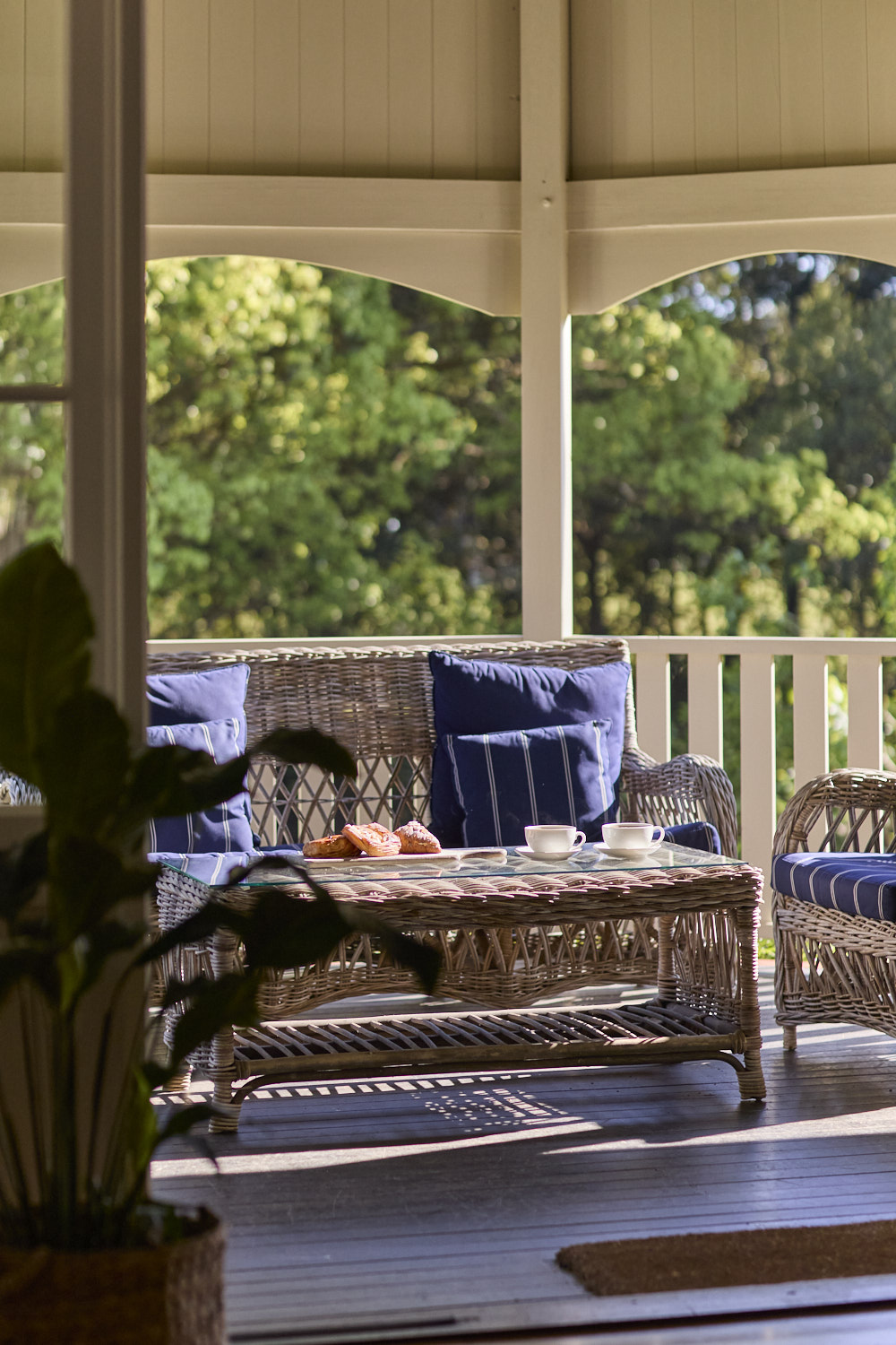 Sitting area on the verandah at The Bangalow Guesthouse overlooking the heritage gardens