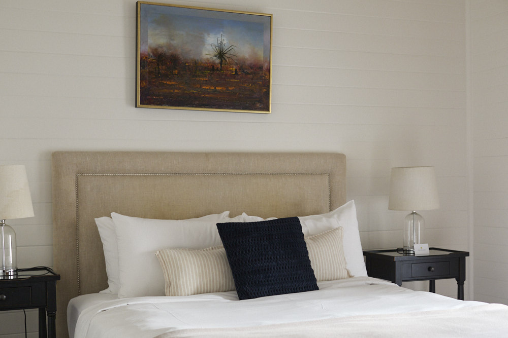 Dr Stewart Suite king bed at The Bangalow Guesthouse with heritage furnishings and soft natural light
