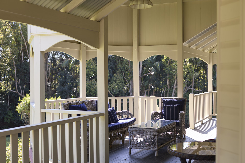 Sweeping heritage verandah at The Bangalow Guesthouse with seating and sunset views