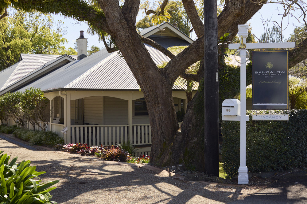 Heritage facade of The Bangalow Guesthouse surrounded by lush gardens in the Byron Bay hinterland