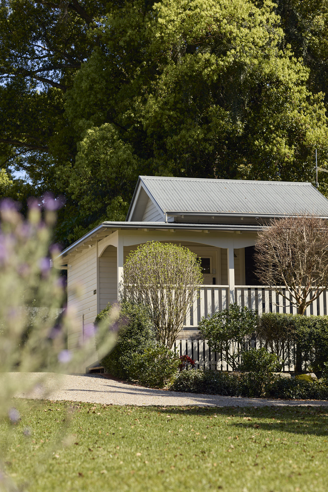 View of Dr Lentaigne’s Cottage at Bangalow Guesthouse from the lush garden surrounded by tropical greenery