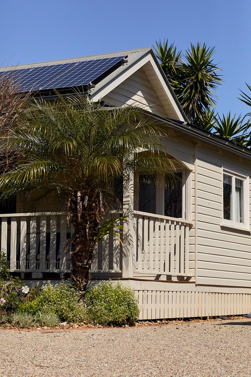 Lawrence Cottage Exterior — Bangalow Guesthouse Exterior view of Lawrence Cottage at Bangalow Guesthouse surrounded by heritage gardens in the Byron Bay hinterland