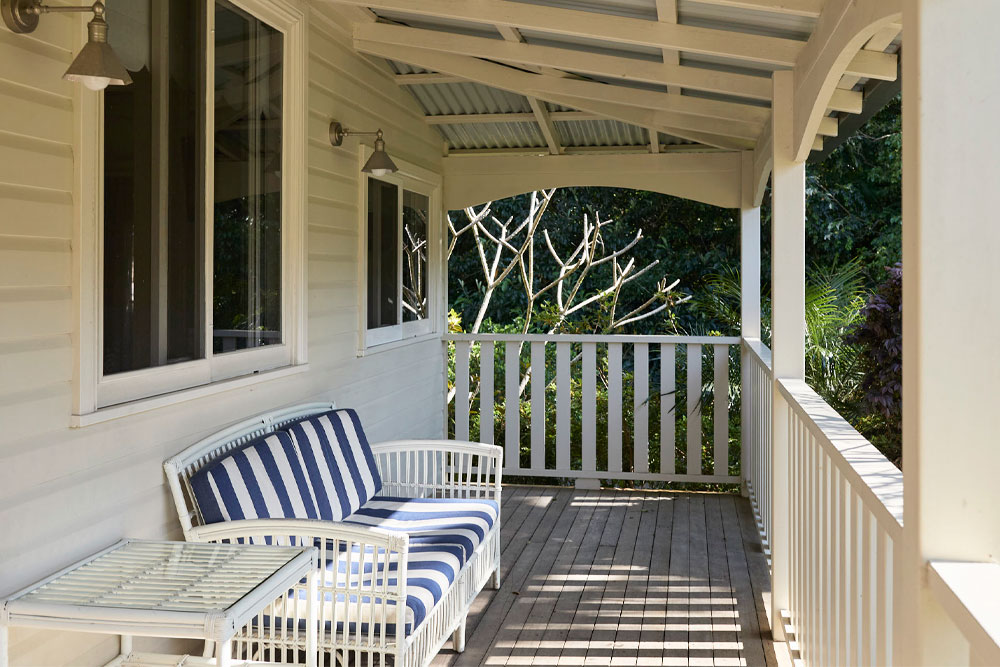 Private Balcony at Lawrence Cottage — Bangalow Guesthouse Private balcony of Lawrence Cottage with comfortable loungers overlooking the gardens at Bangalow Guesthouse Byron Bay hinterland