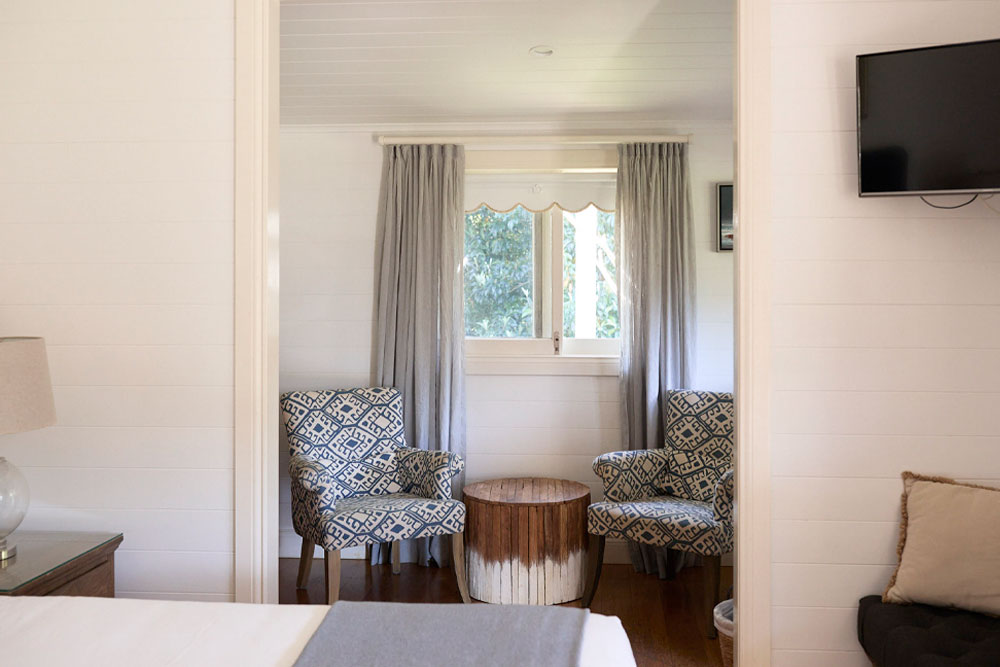 Lawrence Cottage Sitting Area — Relax and Unwind Lawrence Cottage sitting area at Bangalow Guesthouse with morning light — perfect for coffee, reading, and peaceful relaxation
